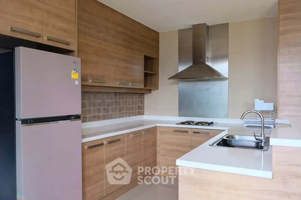 Modern kitchen with sleek wooden cabinets and stainless steel appliances