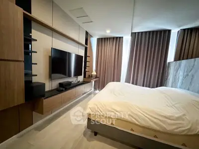 Modern bedroom with sleek design and large TV, featuring elegant curtains and stylish wooden accents.