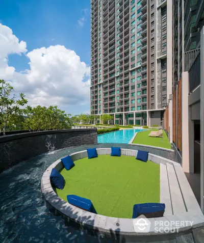 Luxurious high-rise apartment with stunning pool and modern outdoor seating area.