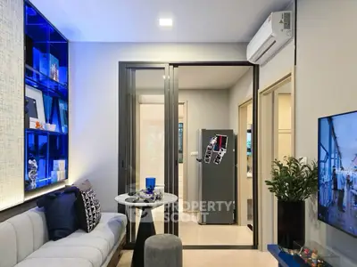 Modern living room with sleek design and stylish decor, featuring a cozy seating area and contemporary shelving.