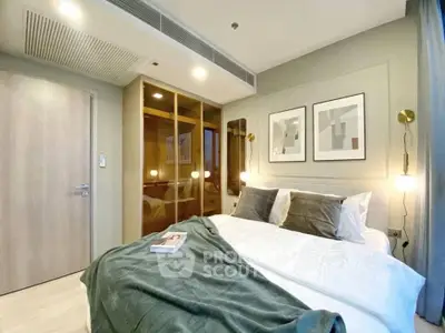 Modern bedroom with cozy bedding and stylish decor in a contemporary apartment.