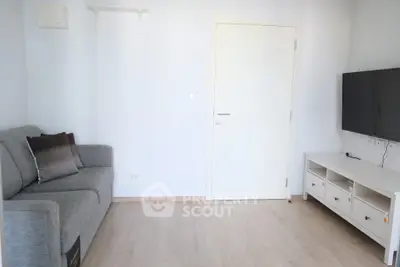 Modern living room with sleek TV setup and cozy gray sofa