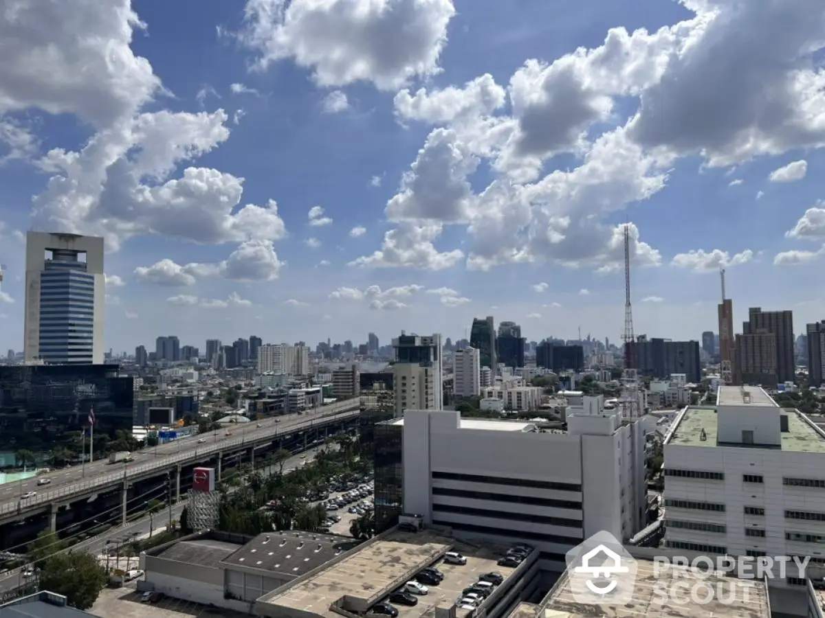 Stunning cityscape view from a high-rise building showcasing urban skyline and blue sky.