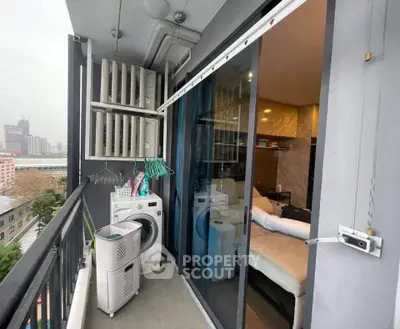 Modern apartment balcony with washing machine and city view