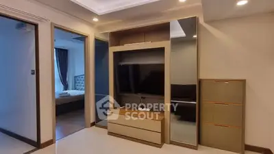 Modern apartment interior with TV unit and bedroom view