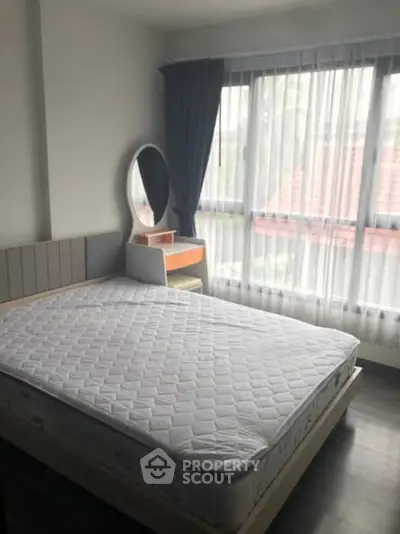 Bright bedroom with large window and modern furnishings