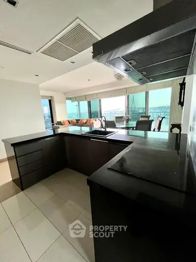 Luxurious open-layout kitchen with stunning city view and modern appliances