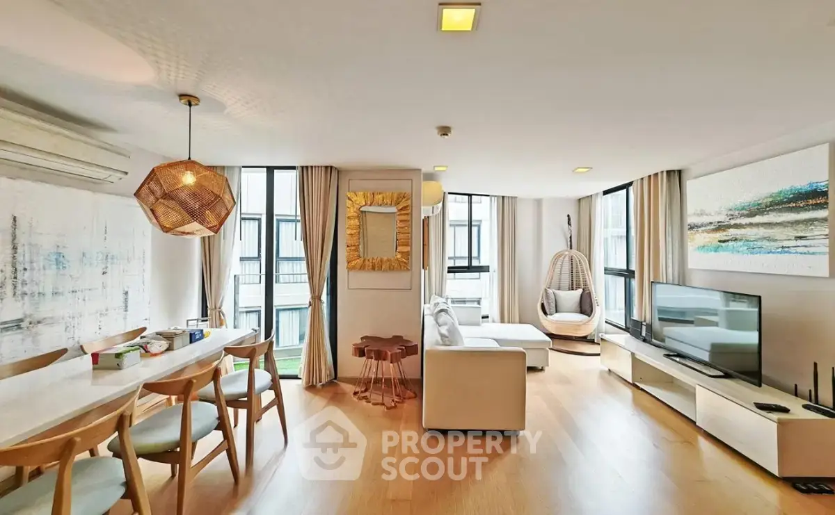 Spacious modern living room with elegant decor and large windows in a luxury apartment.
