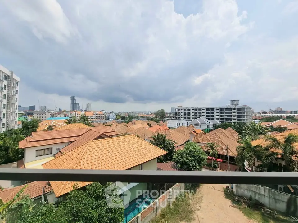 Scenic view of suburban rooftops with city skyline in the background
