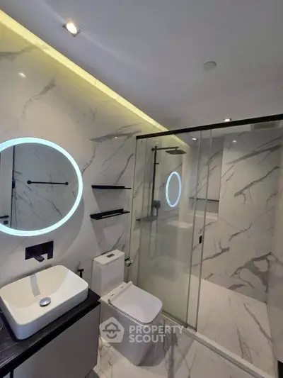 Luxurious modern bathroom with marble walls and sleek fixtures