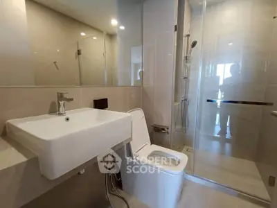 Modern bathroom with sleek fixtures and glass shower enclosure