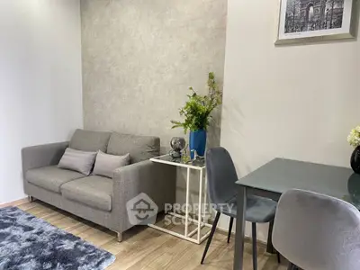 Stylish modern living room with cozy gray sofa and elegant dining area