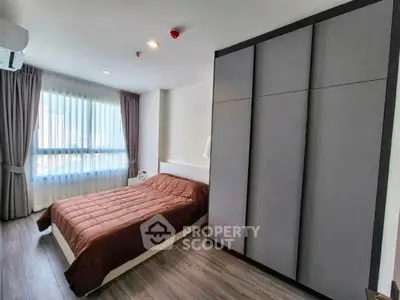 Modern bedroom with large window and sleek wardrobe design