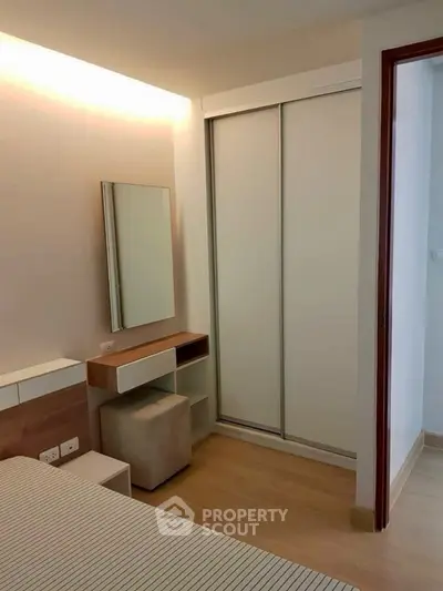 Modern bedroom with sleek closet and vanity in minimalist design