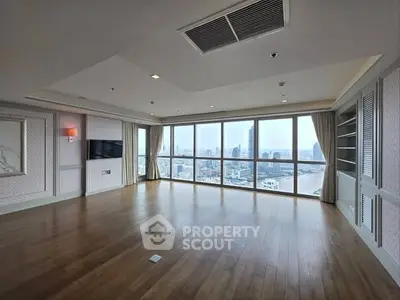 Spacious corner unit living room with panoramic city views and elegant wooden flooring.