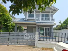 Charming two-story house with modern design and spacious driveway in a serene neighborhood.