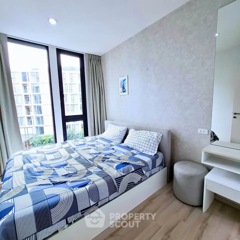 Modern bedroom with large windows and stylish decor in urban apartment