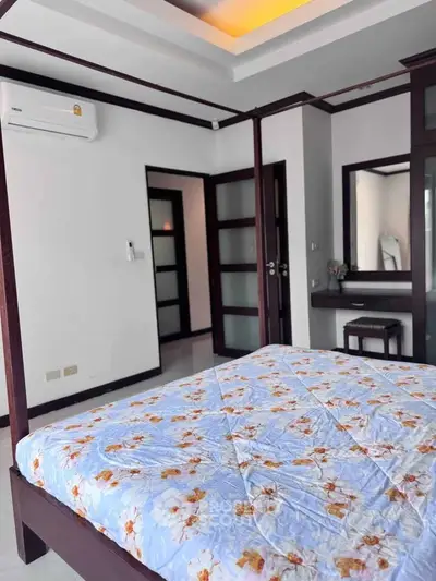 Spacious bedroom with elegant four-poster bed and modern decor, perfect for relaxation and comfort.