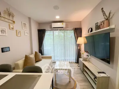 Modern living room with stylish decor, large window, and cozy seating area.