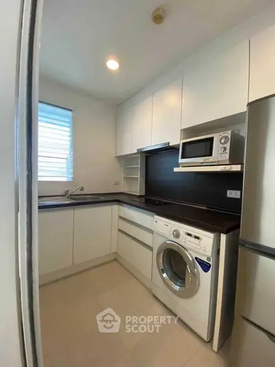 Modern kitchen with sleek white cabinets and built-in appliances