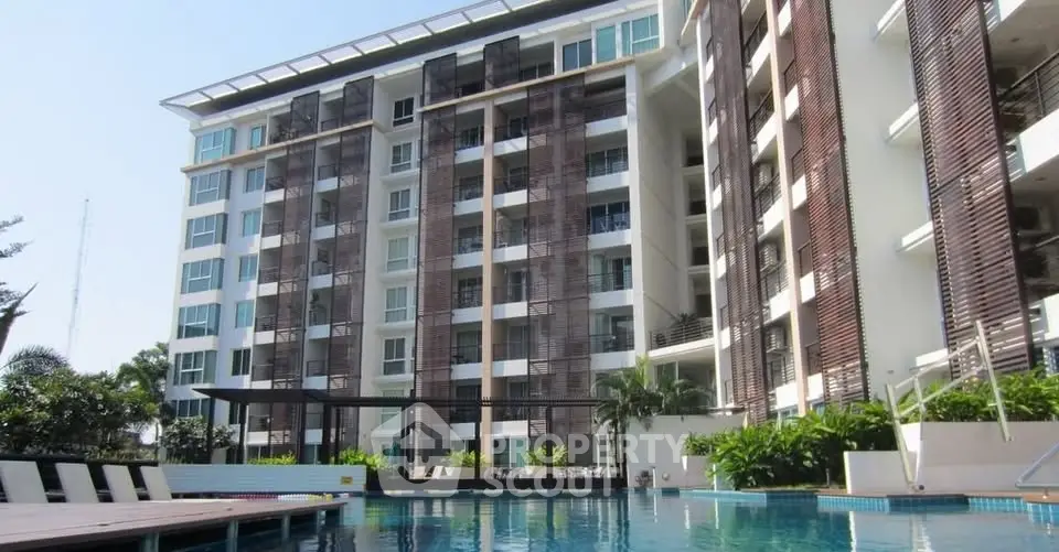 Modern condominium with pool and lush greenery, perfect for luxury living.