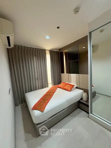 Cozy bedroom with modern decor and mirrored closet doors