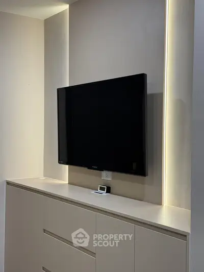Modern living room with sleek TV setup and ambient lighting