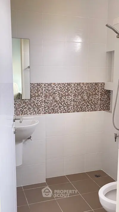 Modern bathroom with stylish mosaic tile accent and sleek fixtures