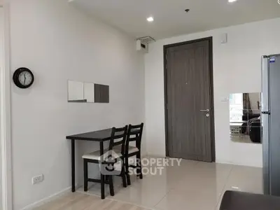Modern apartment entrance with dining area and sleek design