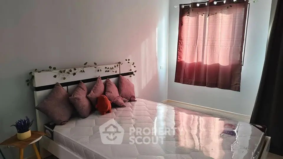 Cozy bedroom with stylish decor and natural light, perfect for relaxation.