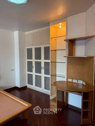 Spacious bedroom with built-in wardrobe and wooden flooring
