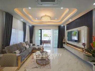 Luxurious modern living room with elegant decor and spacious layout, featuring a stylish ceiling design and large windows.
