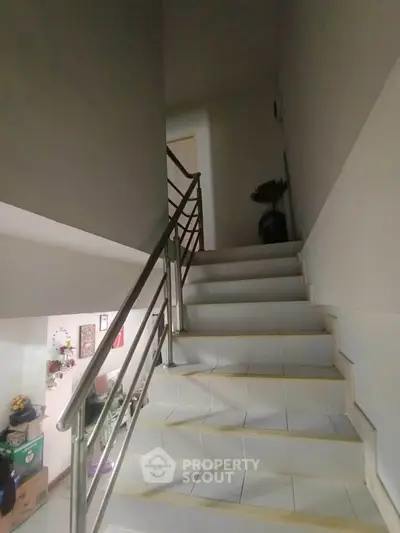 Modern staircase with sleek metal railing in a contemporary home interior