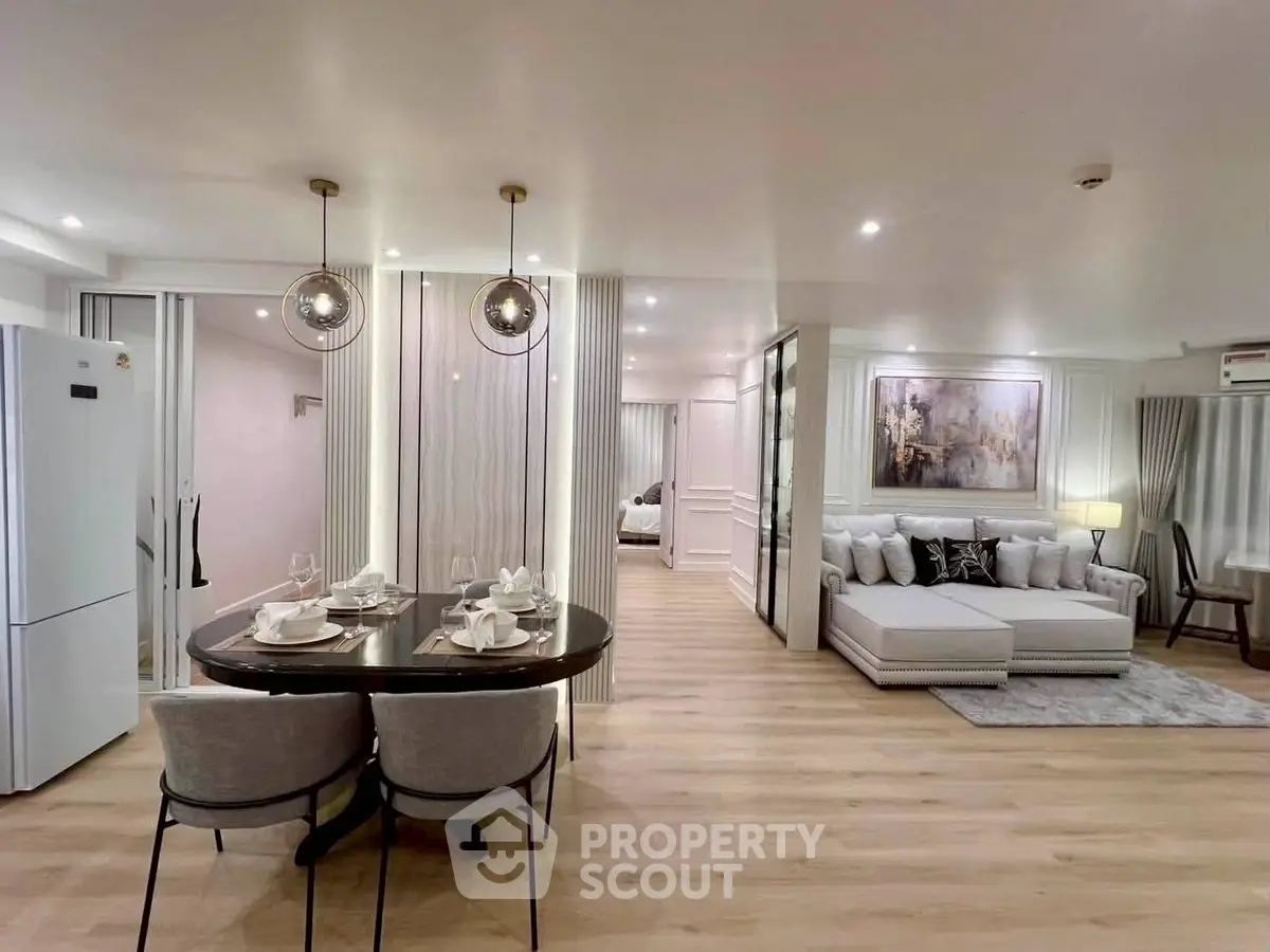 Luxurious open-plan living room with elegant dining area and modern decor