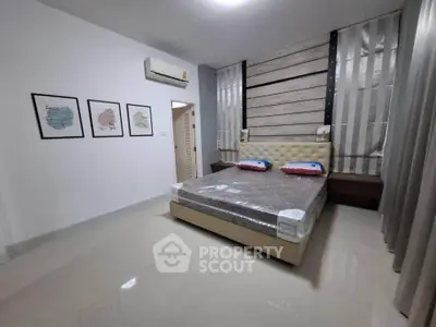 Modern bedroom with stylish decor and comfortable bed in a contemporary apartment.