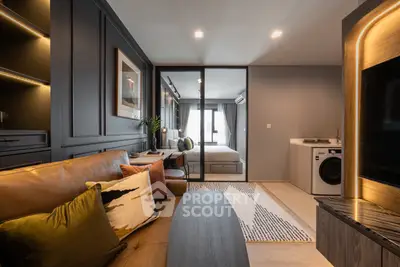 Modern living room with stylish decor and integrated washing machine in a cozy apartment.