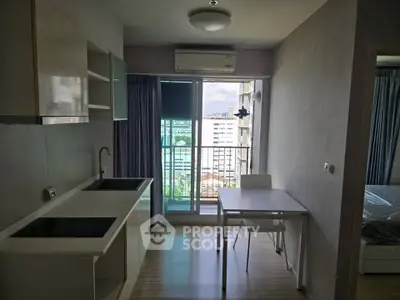 Modern apartment kitchen with open layout and balcony view