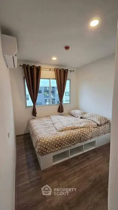 Cozy bedroom with modern decor and large window for natural light