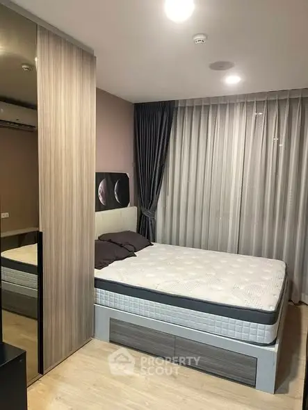 Modern bedroom with stylish decor and large window for natural light