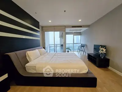 Spacious modern bedroom with city view and stylish decor
