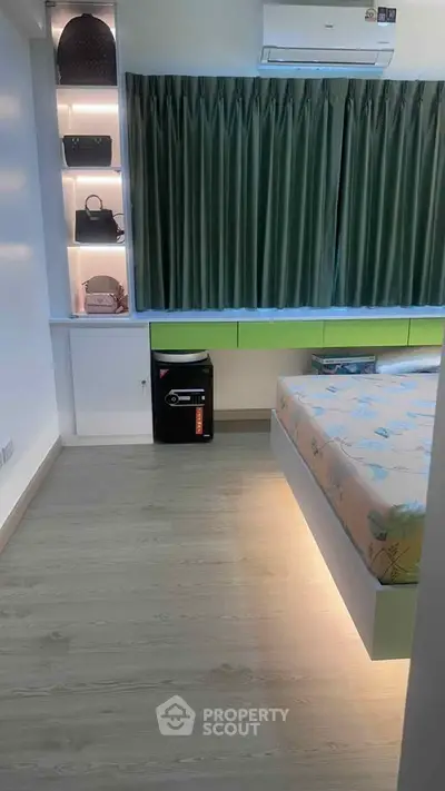 Modern bedroom with stylish shelving and under-bed lighting