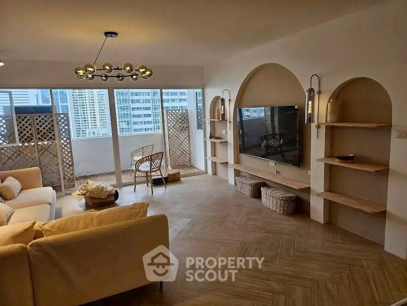 Spacious living room with modern decor and large windows offering city views.