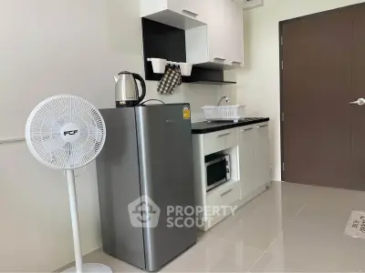 Modern compact kitchen with sleek appliances and minimalist design