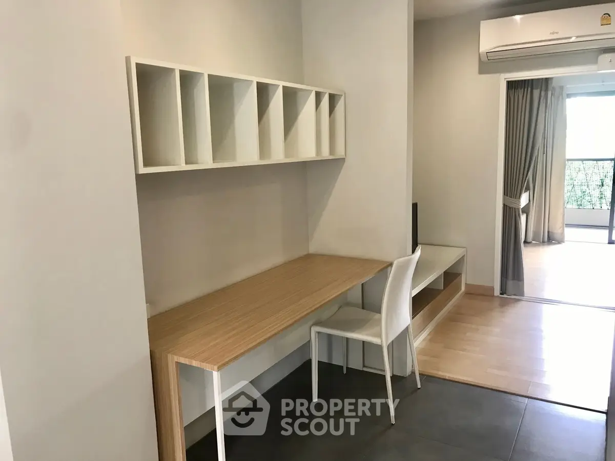 Modern study area with built-in desk and shelving in a bright apartment