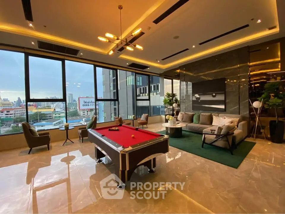 Luxurious living room with pool table and city view, perfect for entertainment and relaxation.