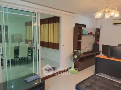 Modern living room with sliding glass doors and elegant dining area