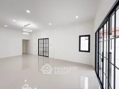 Spacious modern living room with sleek lighting and large windows