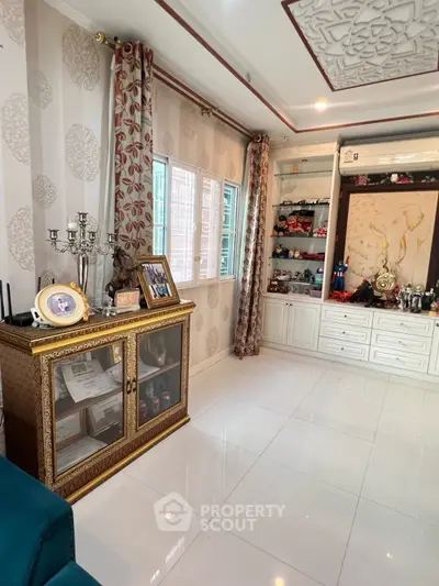 Elegant living room with ornate decor and display cabinet