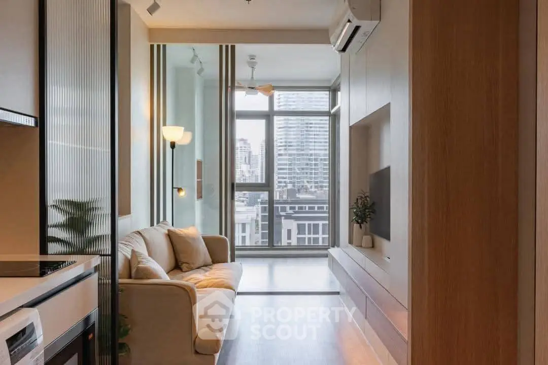 Modern living room with city view, featuring cozy sofa and sleek built-in storage.