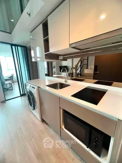 Modern kitchen with sleek appliances and open layout in stylish apartment